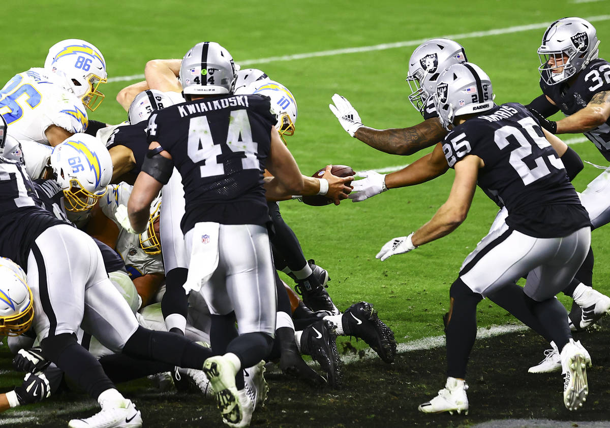 Los Angeles Chargers quarterback Justin Herbert (10) scores a touchdown to defeat the Raiders i ...