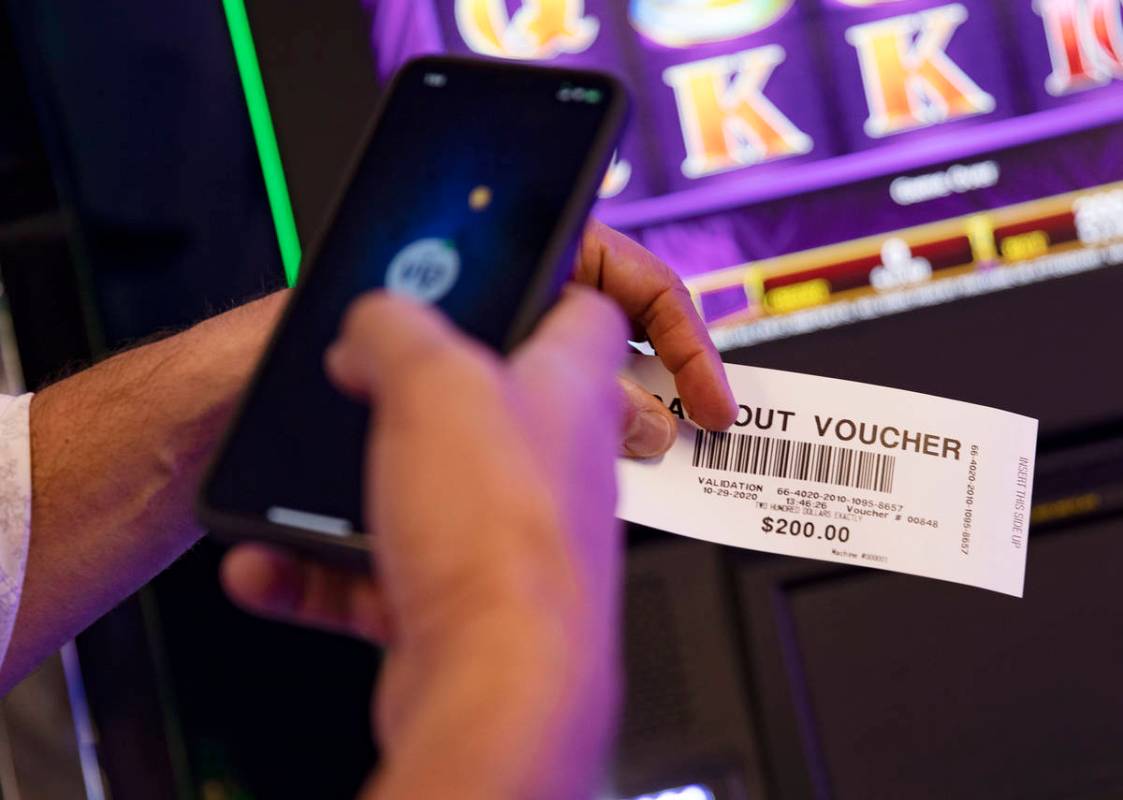 Christopher Justice, president of Global Payments Gaming Solutions, shows the Review-Journal a ...