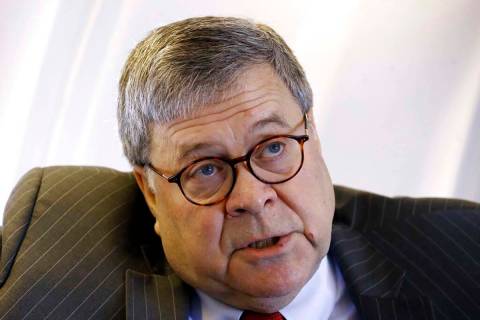 Attorney General William Barr speaks with an Associated Press reporter onboard an aircraft en r ...