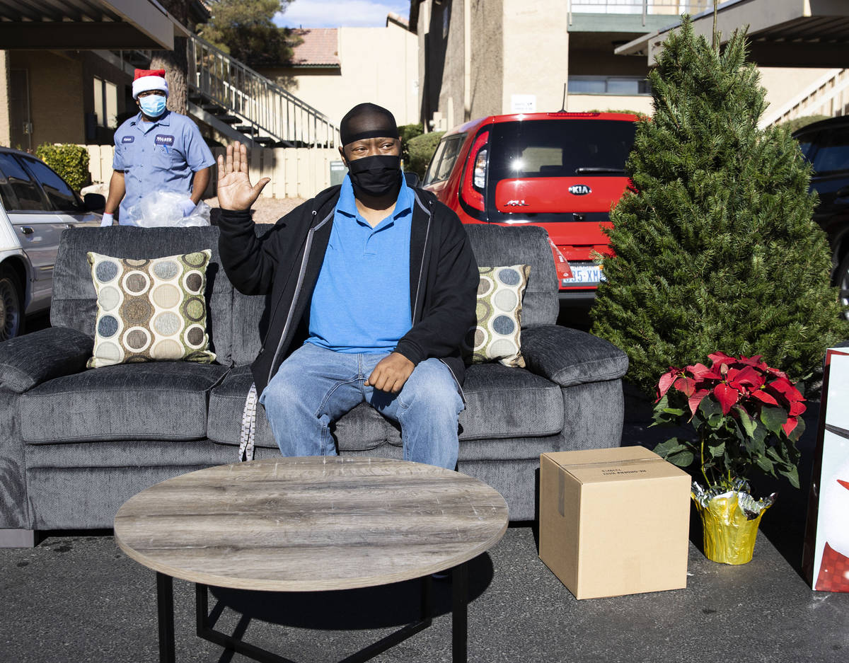 Carl Andrews reacts after his new furniture from Walker Furniture and a Christmas tree from Sta ...