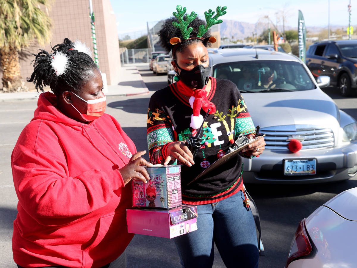 Social worker Emma Dellaud, left, and Vice Principal Frances Lucero deliver gifts at Martinez E ...