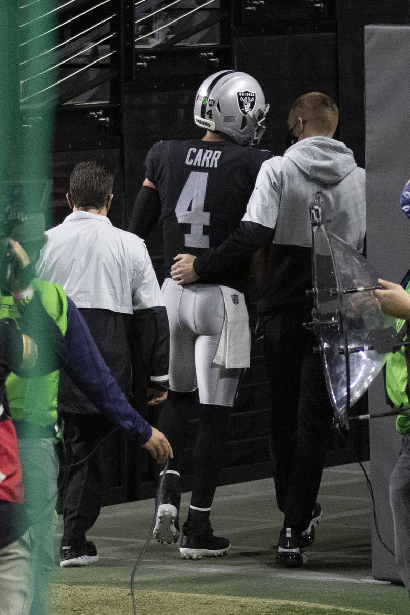 Raiders quarterback Derek Carr (4) exits the game for the locker room after injuring his groin ...
