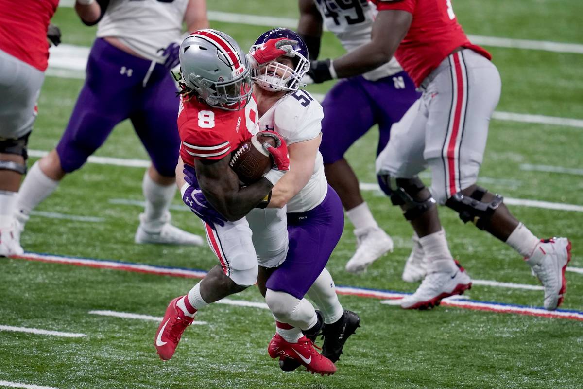 Ohio State running back Trey Sermon (8) runs with the ball as Northwestern linebacker Blake Gal ...