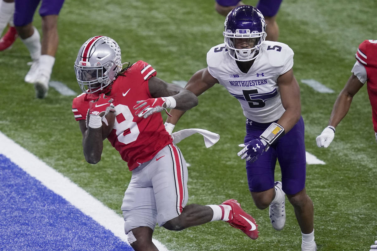 Ohio State running back Trey Sermon (8) scores past Northwestern defensive back JR Pace (5) dur ...