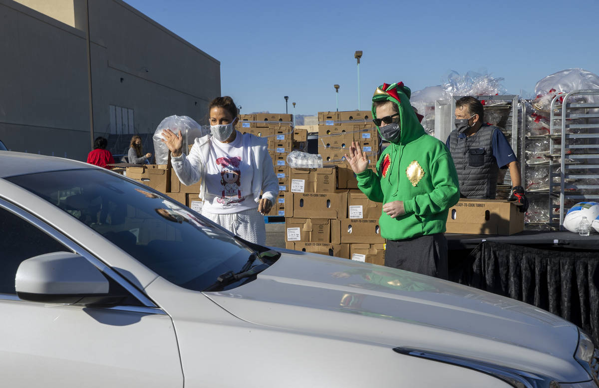 Jade Simone, left, and Piff the Magic Dragon greet another motorist during the re-opening of th ...
