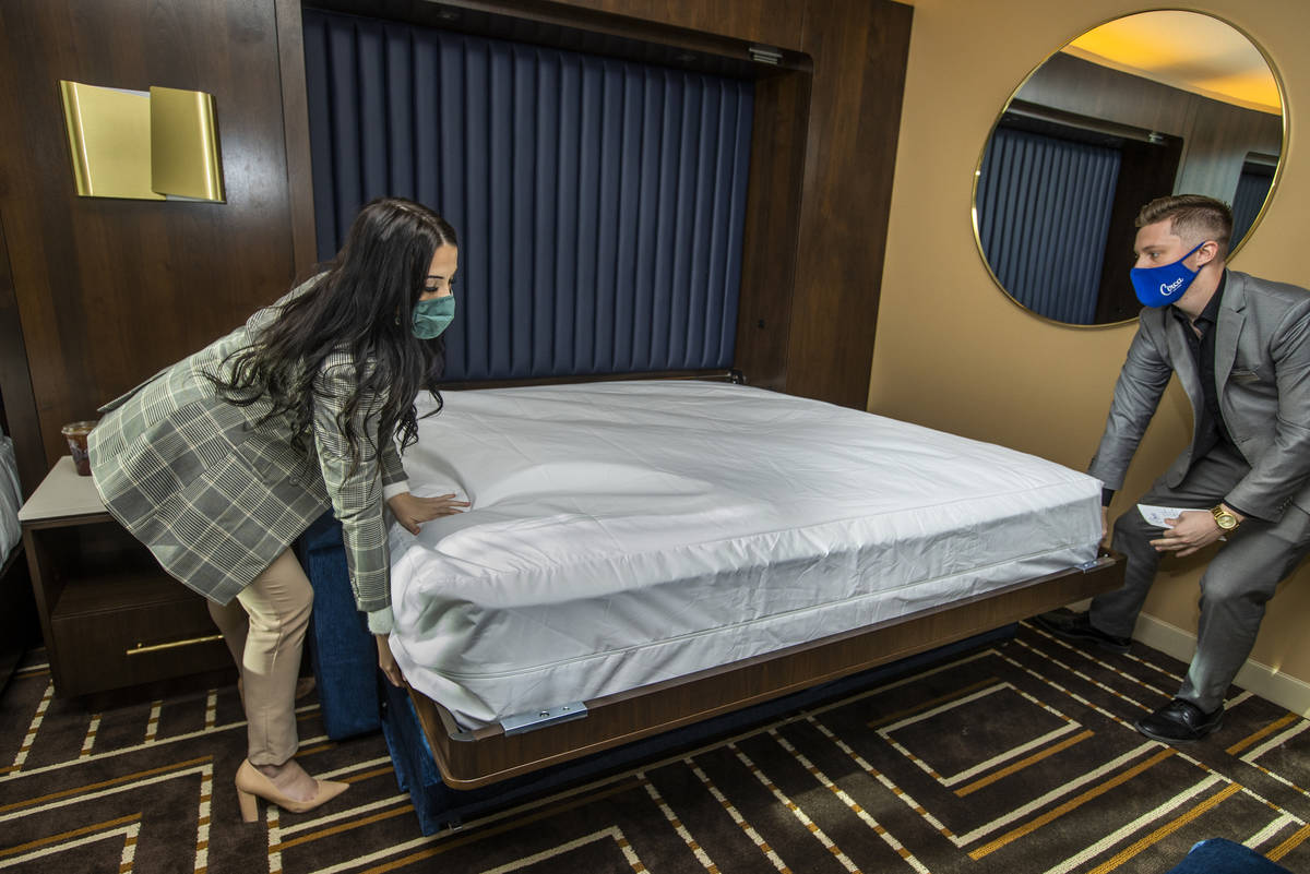 Media Relations Alex Hurley, left, and Hotel Supervisor Trent Becker lower a second bed availab ...