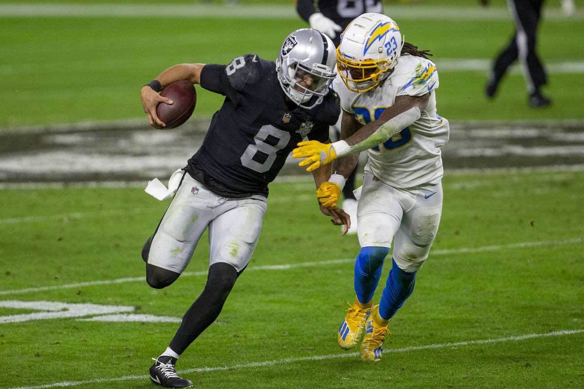 Raiders quarterback Marcus Mariota (8) runs with the football as Los Angeles Chargers strong sa ...