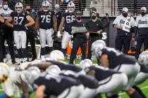 Raiders head coach Jon Gruden, center, watches a play ensue in the fourth quarter during an NFL ...