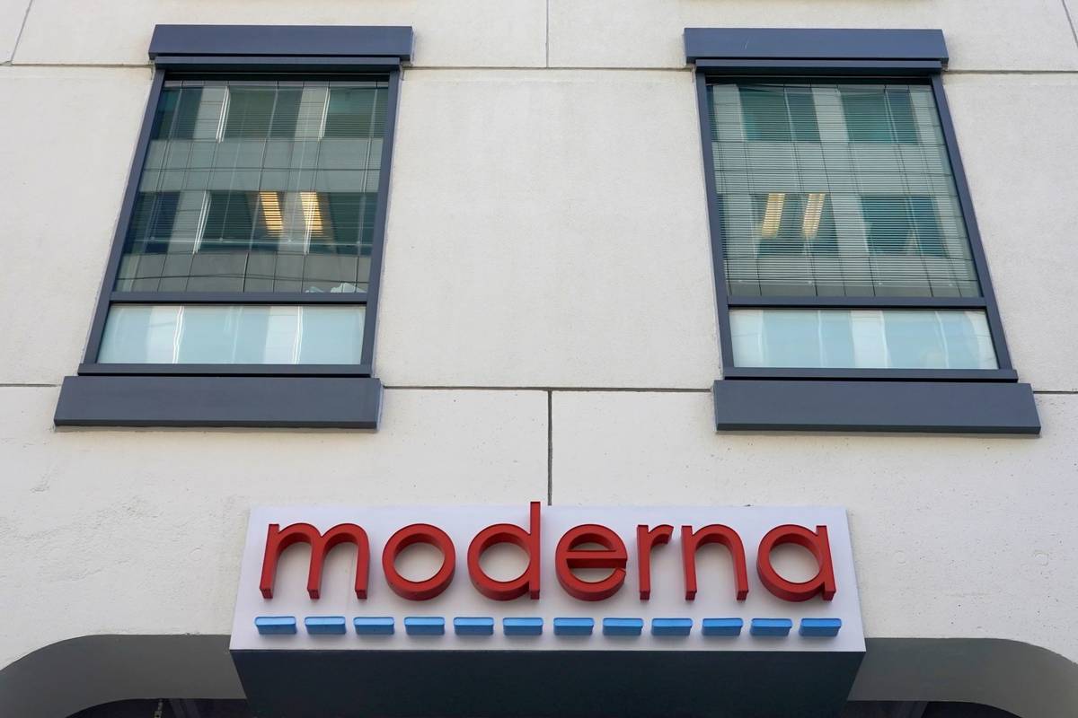 A sign for Moderna, Inc. hangs on its headquarters in Cambridge, Mass. (AP Photo/Elise Amendola)