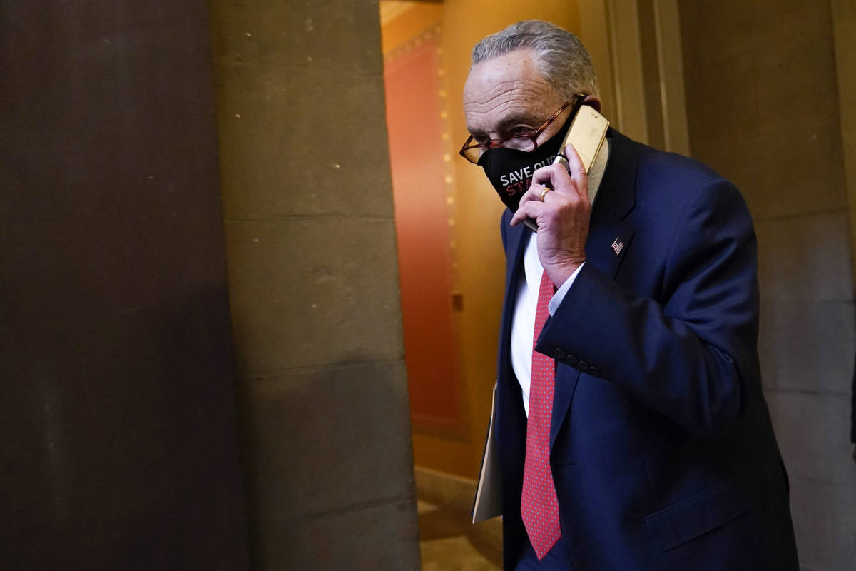 Senate Minority Leader Sen. Chuck Schumer of N.Y., walks on Capitol Hill in Washington, Tuesday ...