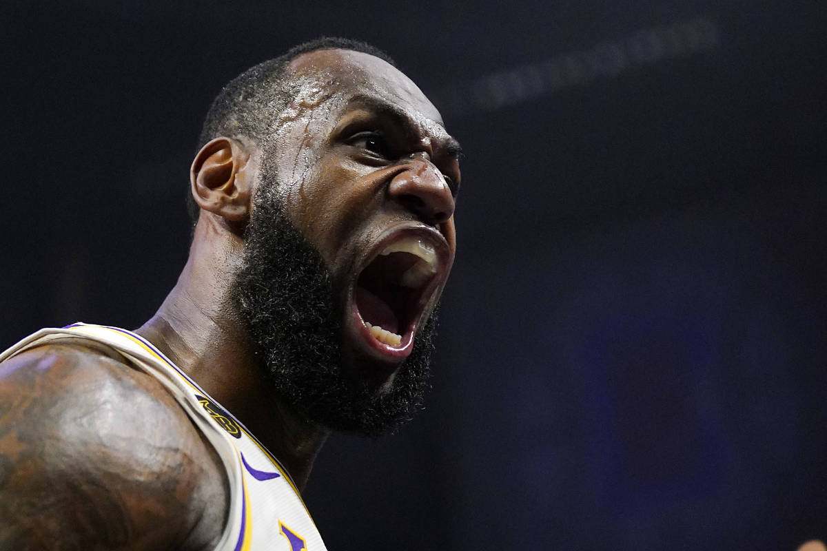Los Angeles Lakers forward LeBron James celebrates after scoring and drawing a foul during the ...