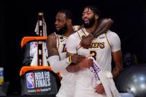 Los Angeles Lakers' LeBron James, rear, and Anthony Davis (3) celebrate after the Lakers defeat ...