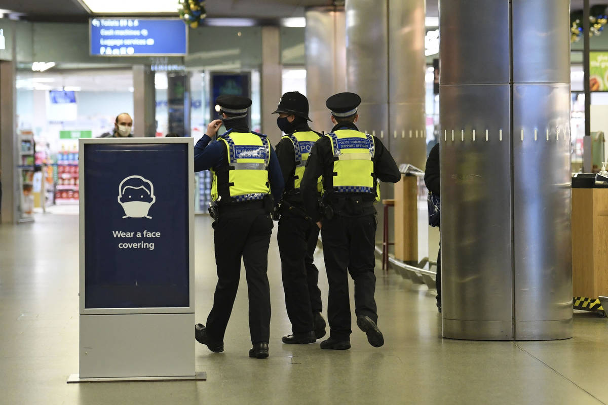 Police officers at St Pancras, with more being deployed to enforce travel rules at London's sta ...