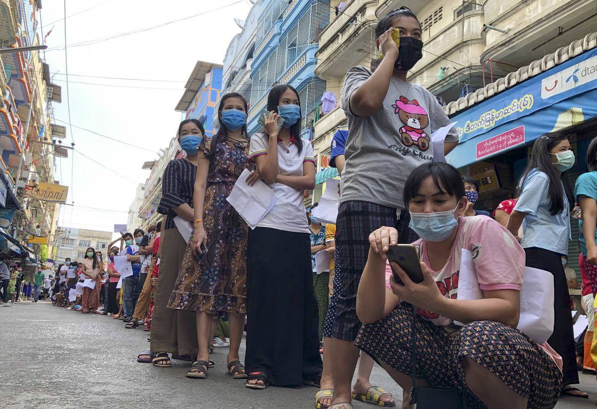 People stand in lines to get COVID-19 tests in Samut Sakhon, South of Bangkok, Thailand, Sunday ...