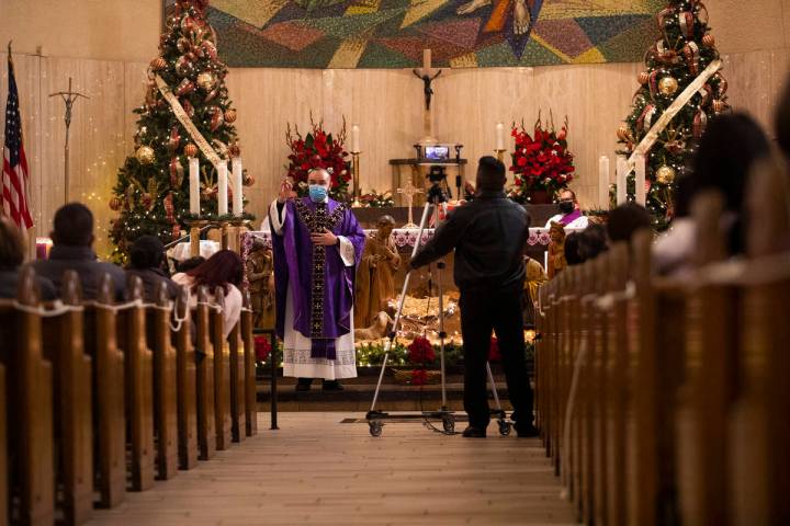 Father Miguel Corral delivers a sermon during Mass at St. Anne's Catholic Church in Las Vegas, ...