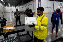 Boxes containing the Moderna COVID-19 vaccine are prepared to be shipped at the McKesson distri ...