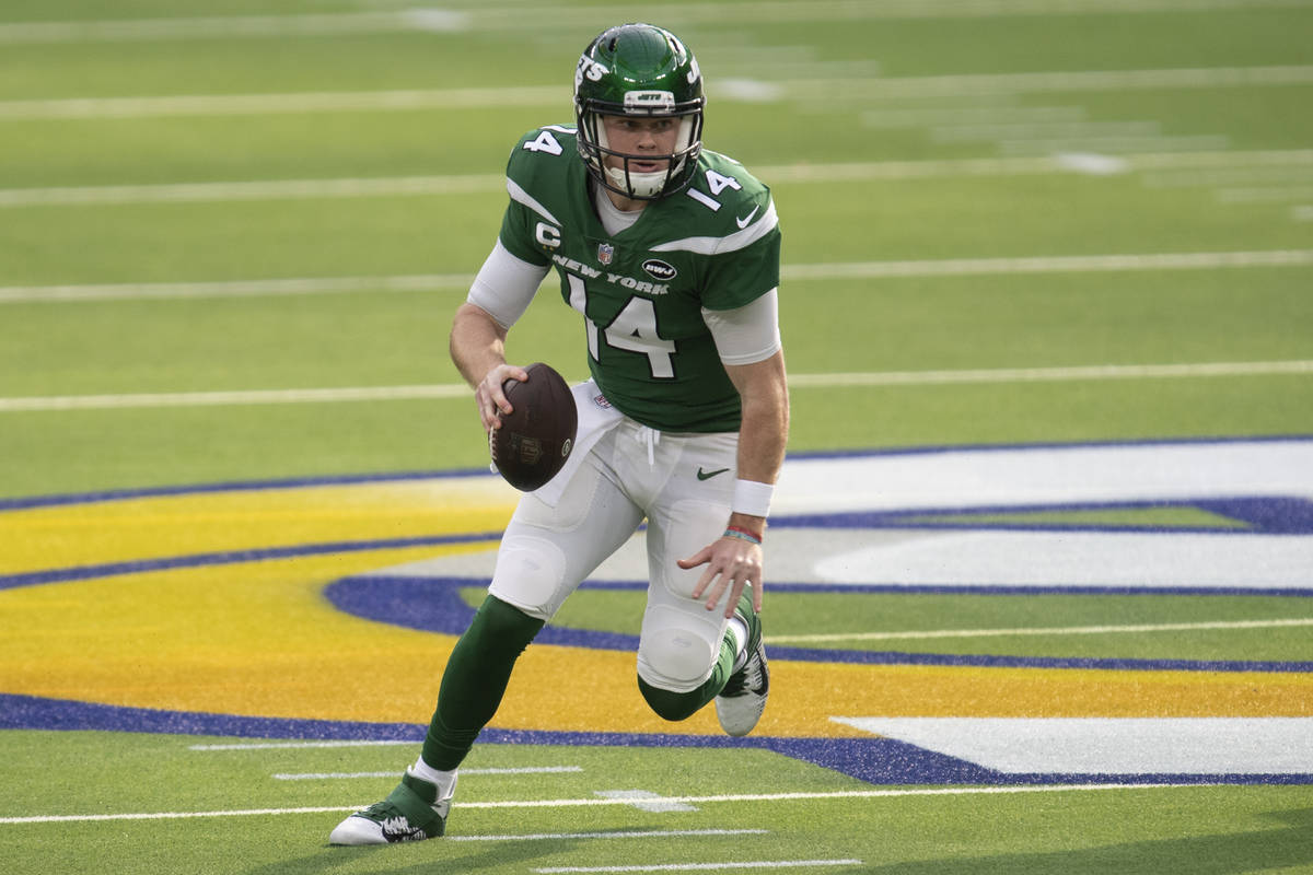 New York Jets quarterback Sam Darnold (14) sprints with the ball during an NFL football game ag ...