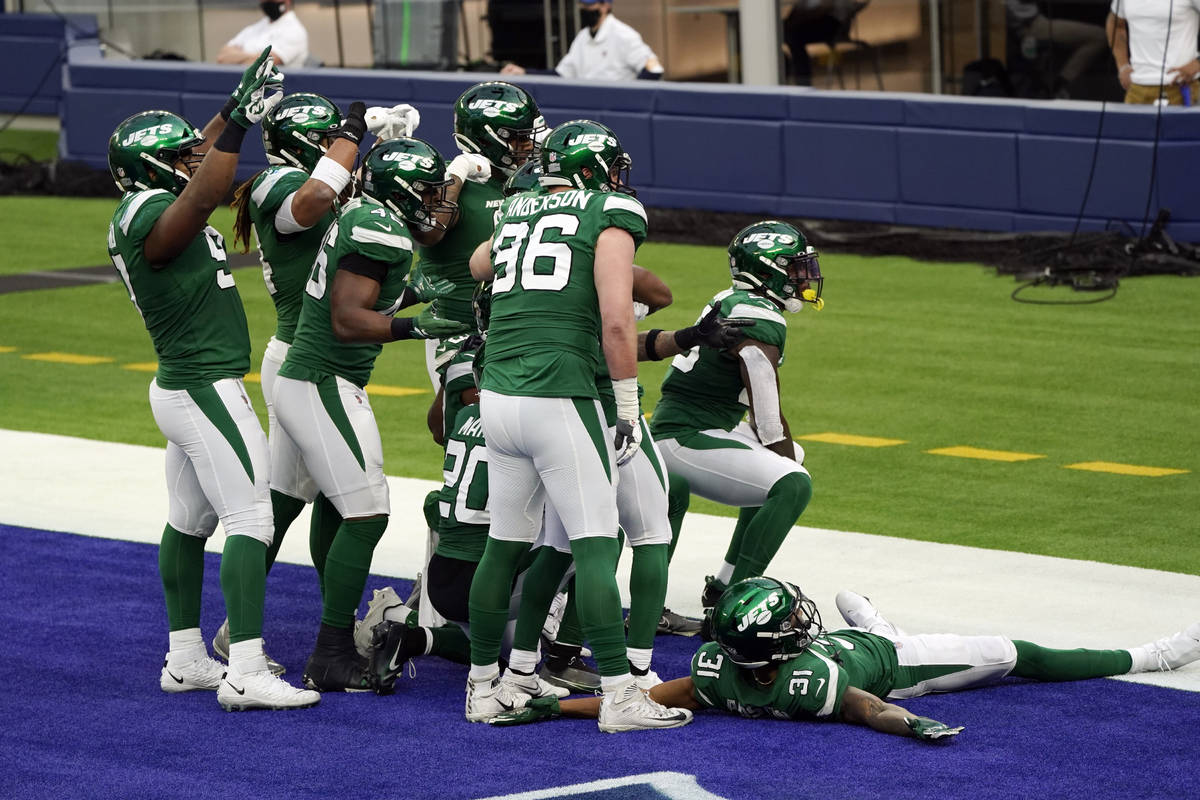 The New York Jets celebrate in the end zone after an intercepted pass by Bryce Hall during the ...