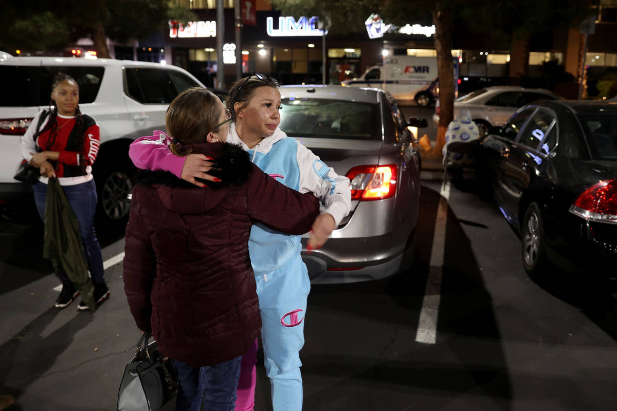Unique Hairston, 36, cousin of Vinston Fortee Davis Jr., 26, hugs her mother Chris Hairston as ...