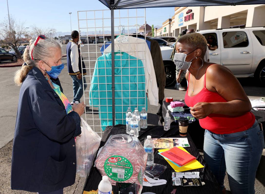 Kenya Young, 39, right, works with Barbara Prentiss, 54, during her coat drive in Historic West ...
