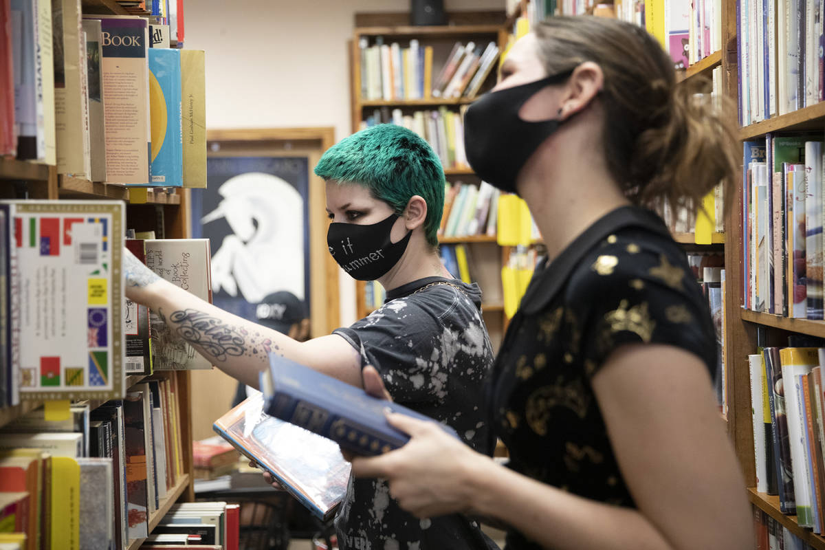 Friends Mercury Taft, left, and Stephanie Lehr, right, shop for books at Amber Unicorn Books. T ...