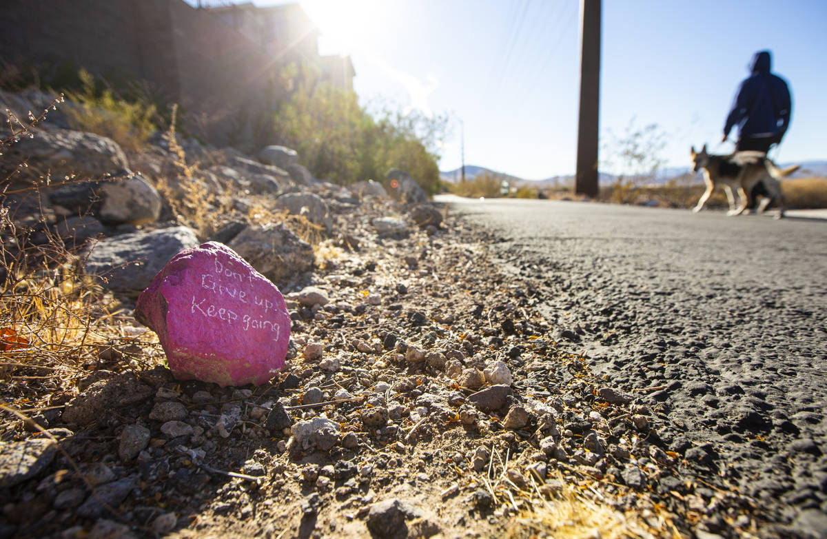 Painted rocks with positive phrases line the Nevada Power Trail in Henderson. (Chase Stevens/La ...