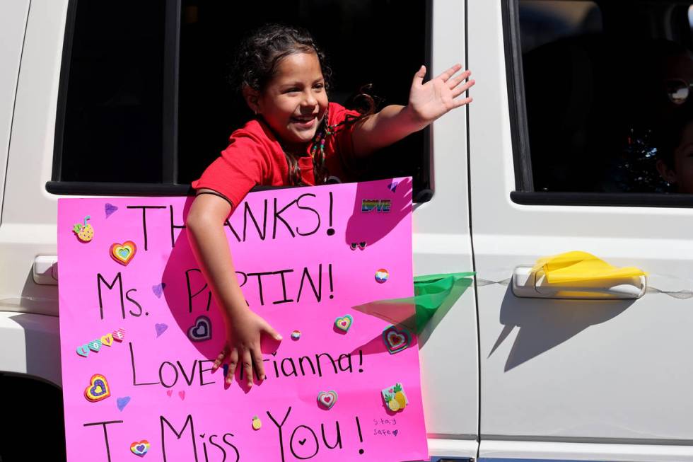 Legacy Traditional School Southwest second grader Arianna Tapia waves during an appreciation pa ...