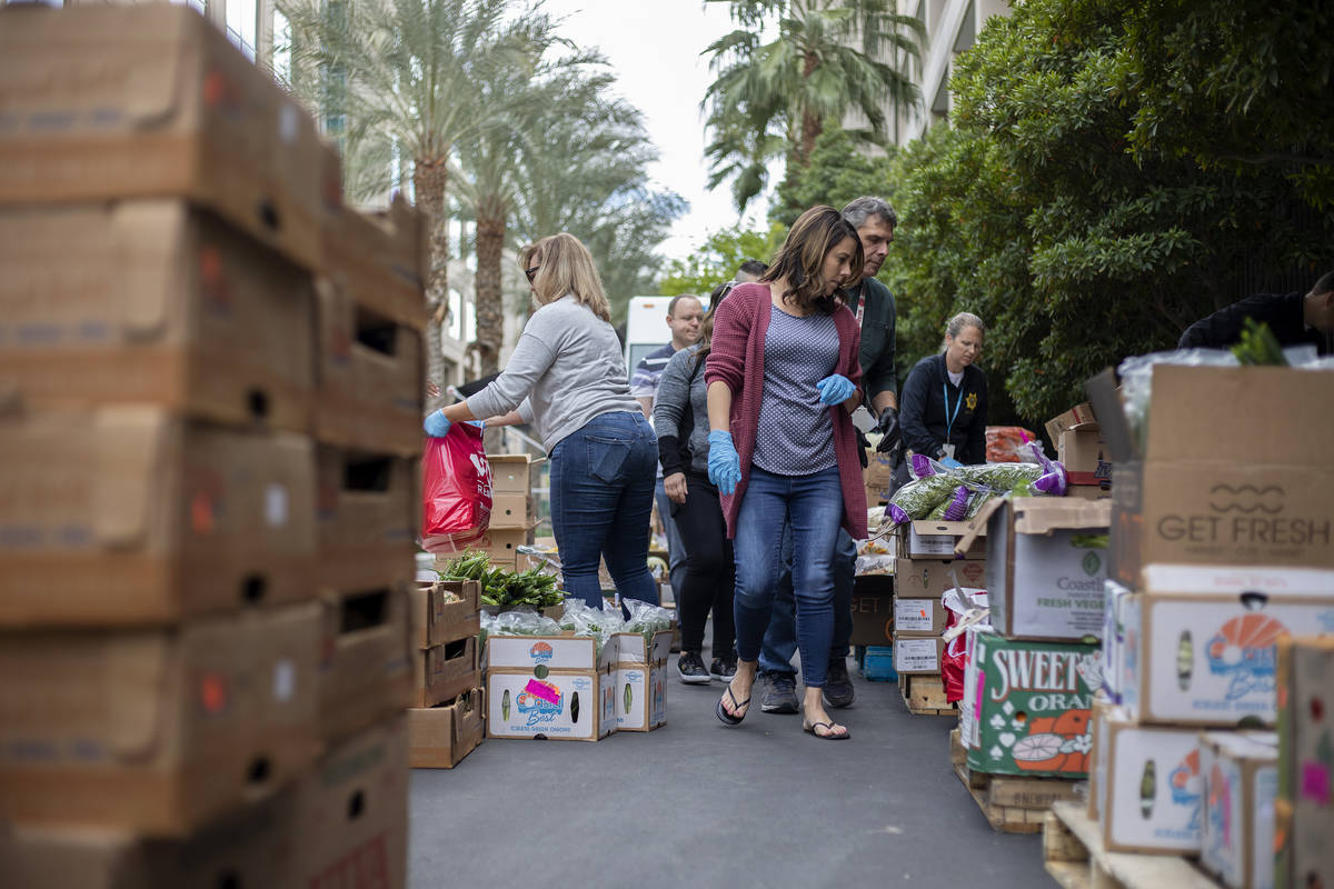 Natalie Lane, the spouse of a Metropolitan police officer, helps put together a food donation o ...