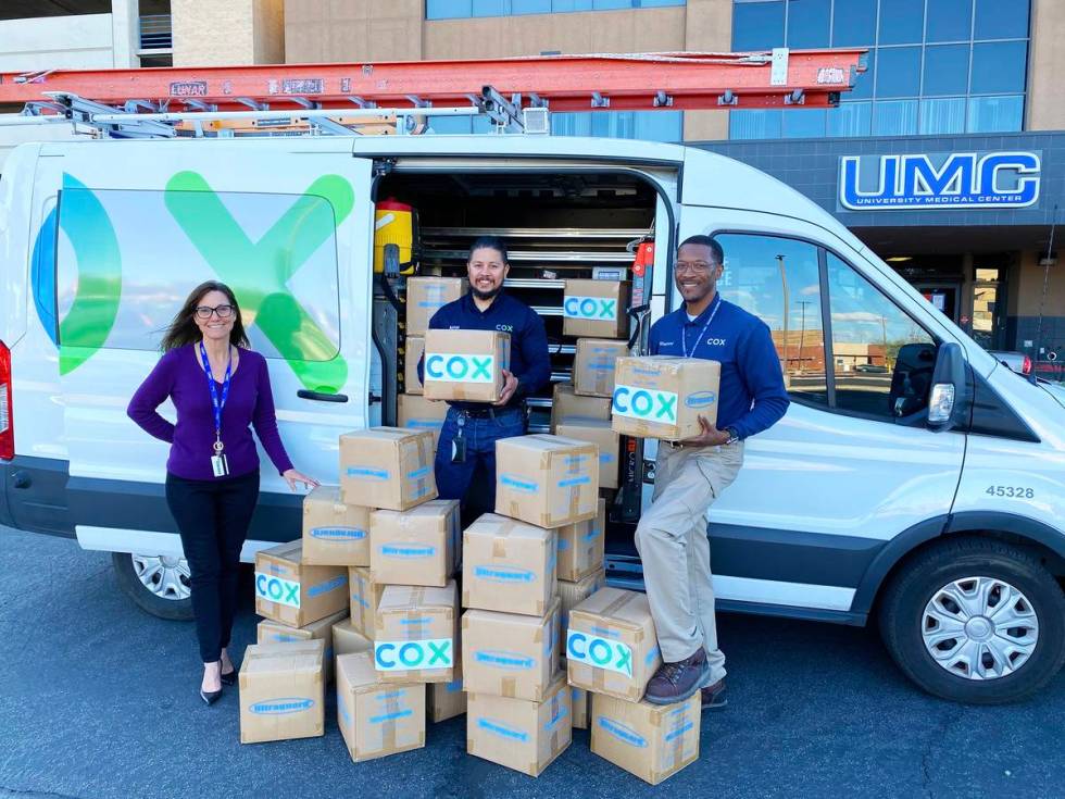 Cox Communications' field technicians Adrian Alcala and Rodney Shepherd donate protective shoe ...
