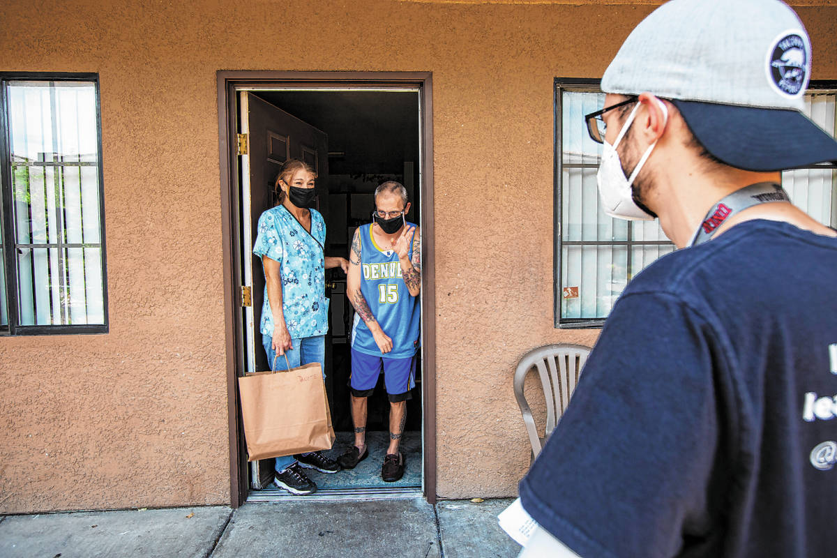 Danette, left, and DJ Rindt thank Delivering with Dignity volunteer Jon Thompson after he dropp ...