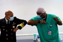 Surgeon General of the U.S. Jerome Adams, left, elbow-bumps Emergency Room technician Demetrius ...
