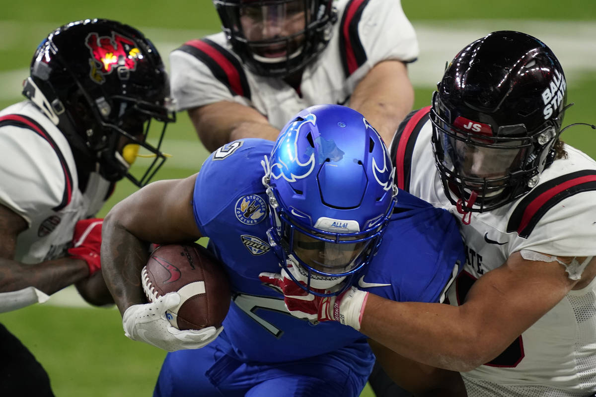 Buffalo running back Ron Cook Jr. (2) is tackled by Ball State's Tye Evans during the second ha ...