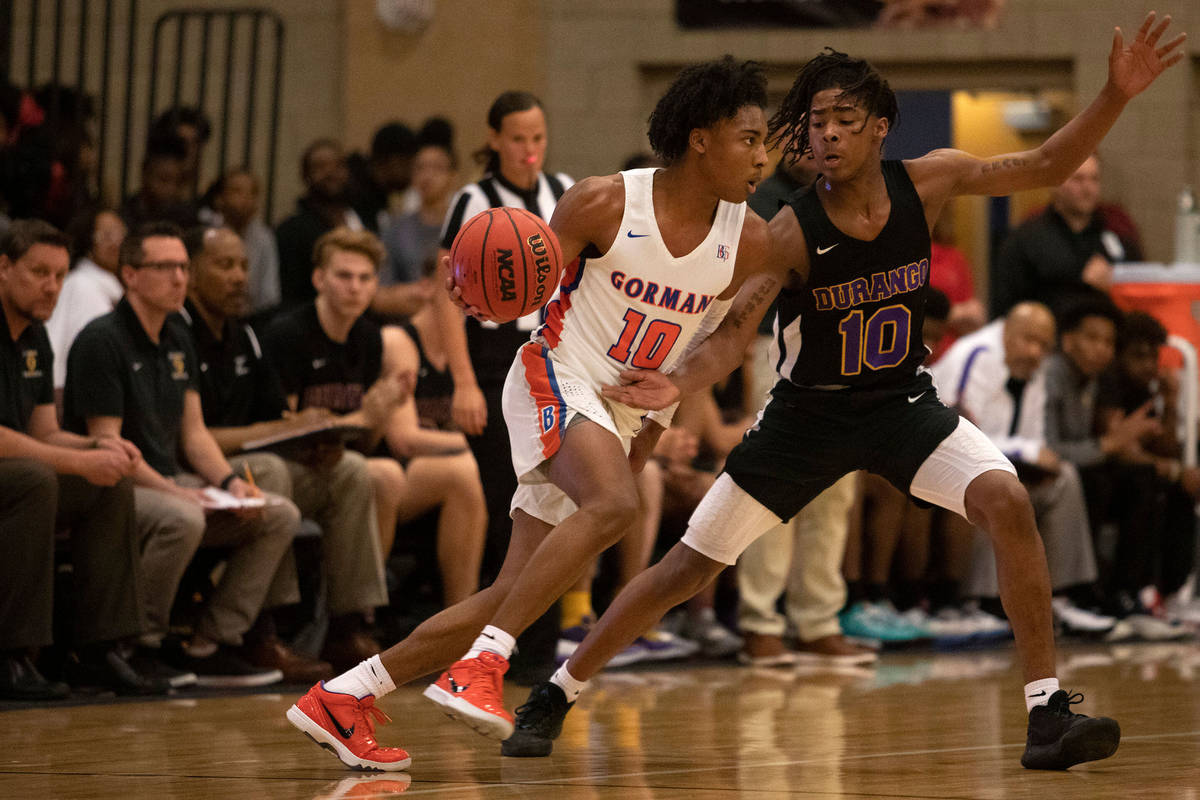 Bishop Gorman's Zaon Collins (10) dribbles past Durango's Keshon Gilbert (10) at Desert Oasis H ...
