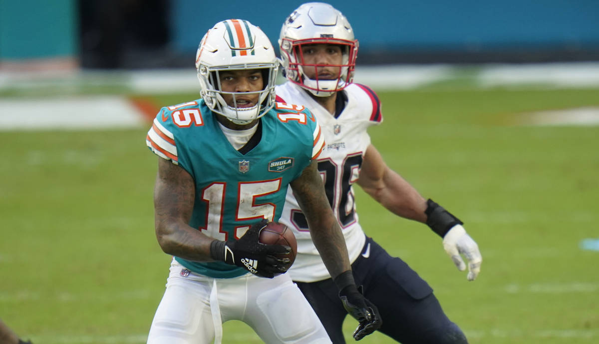 Miami Dolphins running back Lynn Bowden (15) runs after a catch against the New England Patriot ...