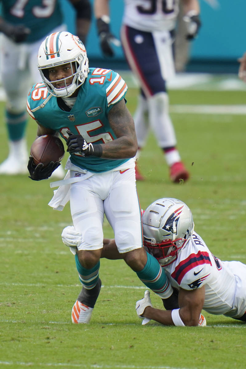 New England Patriots cornerback Myles Bryant (41) tackles Miami Dolphins running back Lynn Bowd ...