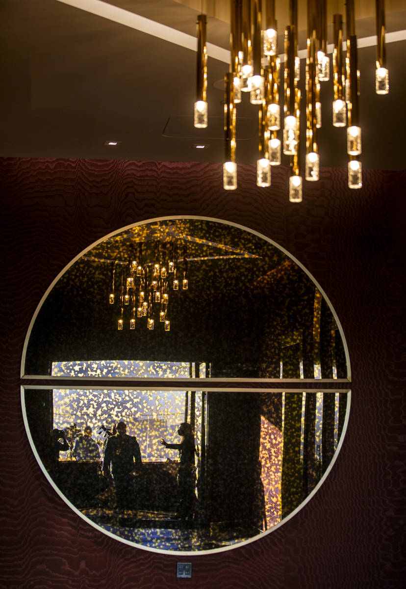Visitors are reflected in a decorative mirror within the Legacy Club at Circa on Tuesday, Dec. ...