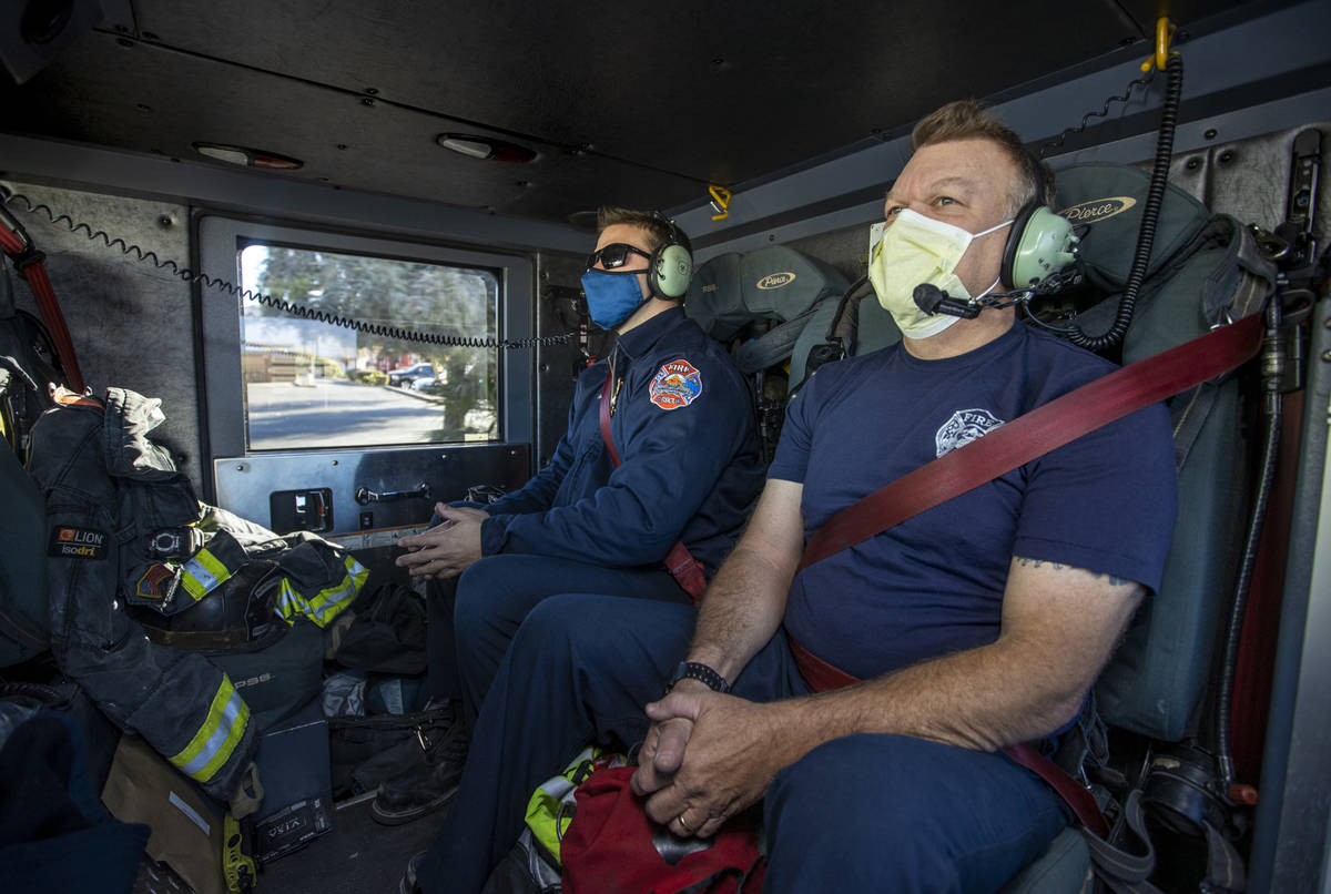 North Las Vegas Fire Truck 52 crew members Tyler Lowry, left, and Pat Johnson make time during ...