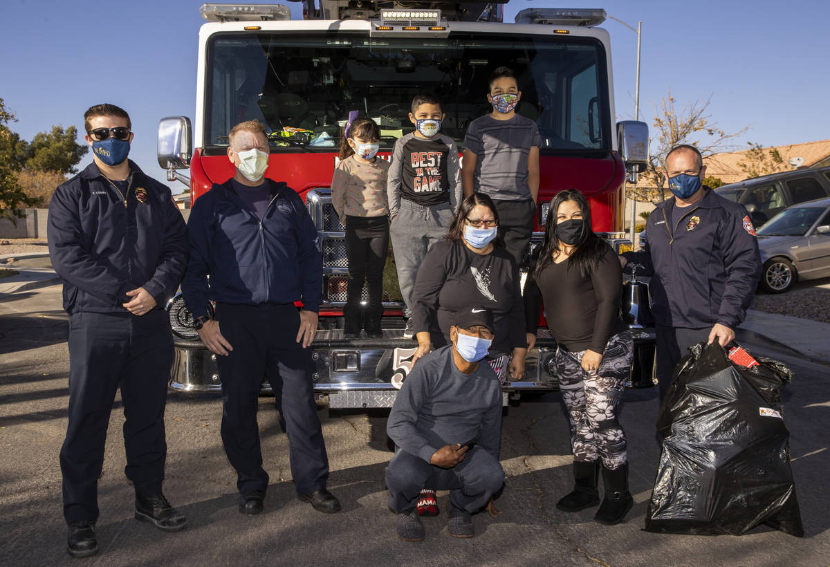 North Las Vegas Fire Truck 52 crew and family members gather after the firefighters delivered C ...