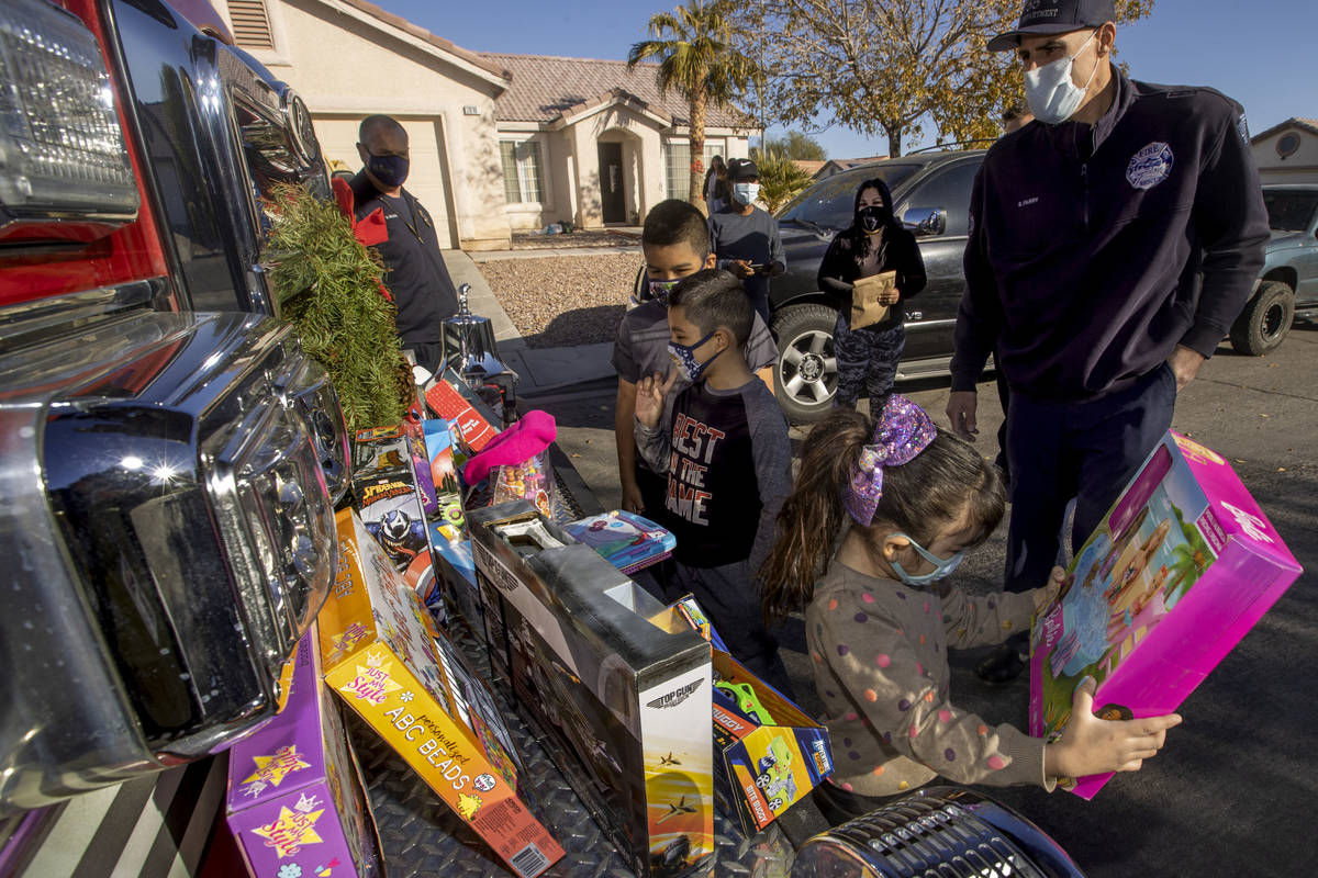 (Clockwise from top right) North Las Vegas Fire Truck 52 crew member Brandon Parry looks on as ...