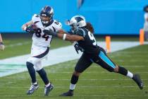 Denver Broncos tight end Troy Fumagalli (84) is chased by Carolina Panthers defensive end Austi ...