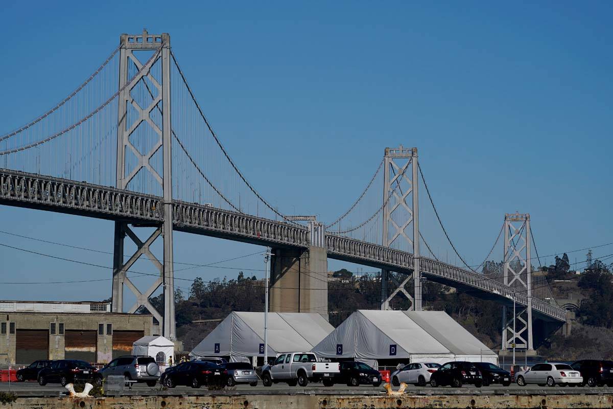 Tents from the CityTestSF at Pier 30/32 COVID-19 testing site sit in front of the San Francisco ...