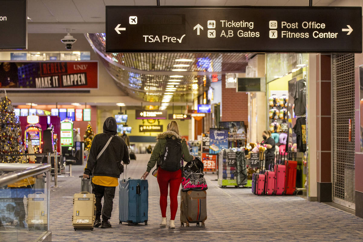 Travelers make their way to ticketing and departure gates at Terminal 1 during holiday travel a ...