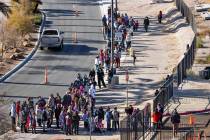 People line up to walk in as the Las Vegas Rescue Mission holds its toy drive on a first-come, ...