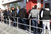People wait in line at One-Stop Career Center on Monday, March 16, 2020, in Las Vegas. (Bizuaye ...