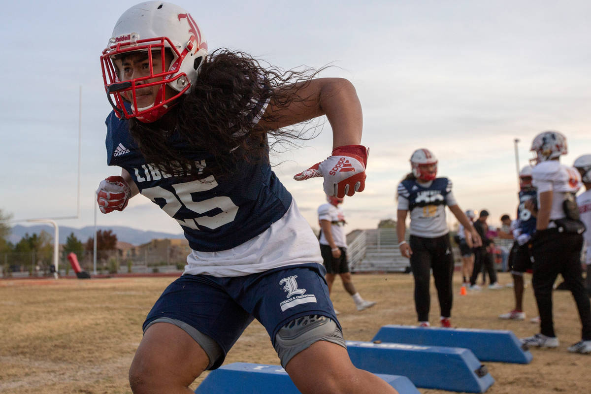 Liberty's inside linebacker Malachi Maika-Lepisi Asuega runs bag drills during football practic ...