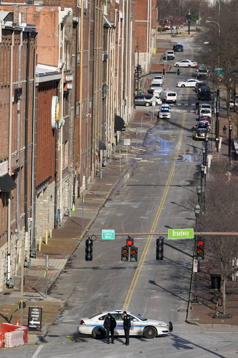 Emergency personnel stand near the scene of an explosion in downtown Nashville, Tenn., Friday, ...