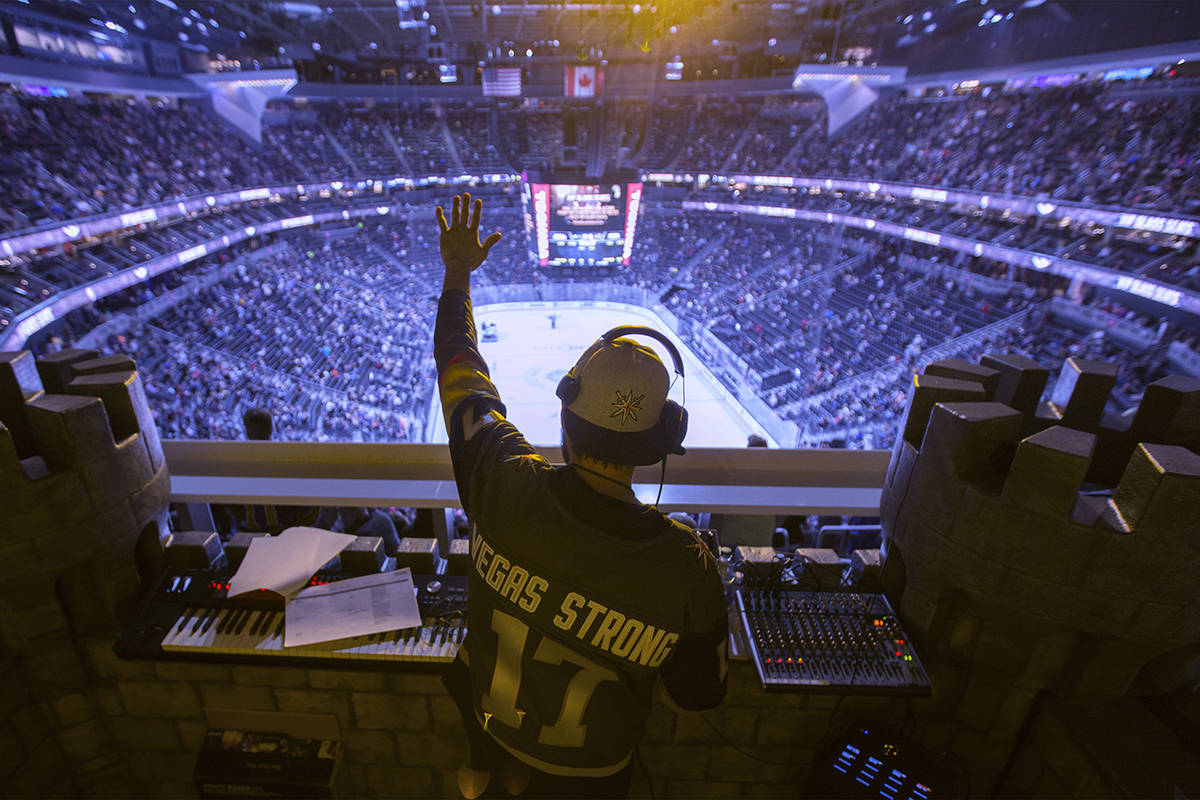 Golden Knights music director Jake Wagner waves to the crowd at the end of the first period dur ...