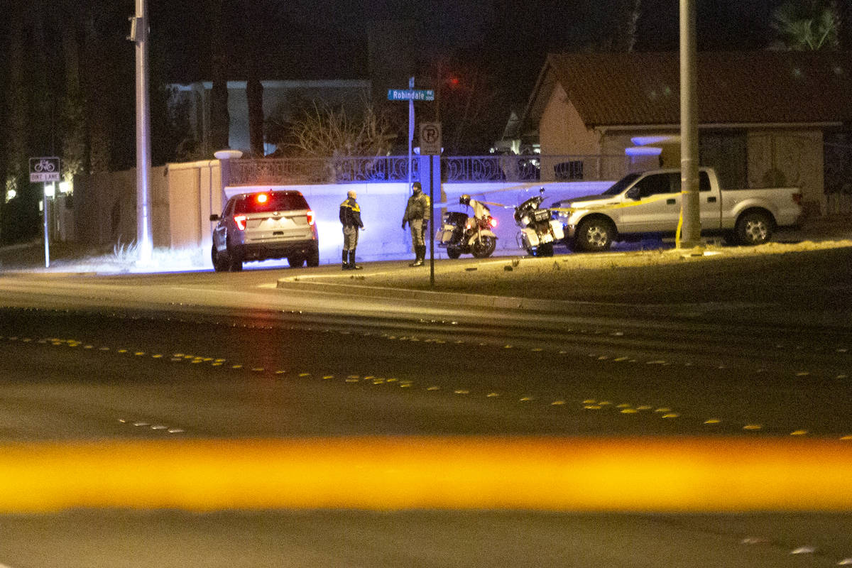 Metropolitan police monitor the scene at Bermuda Road and East Windmill Lane, where a motorcycl ...