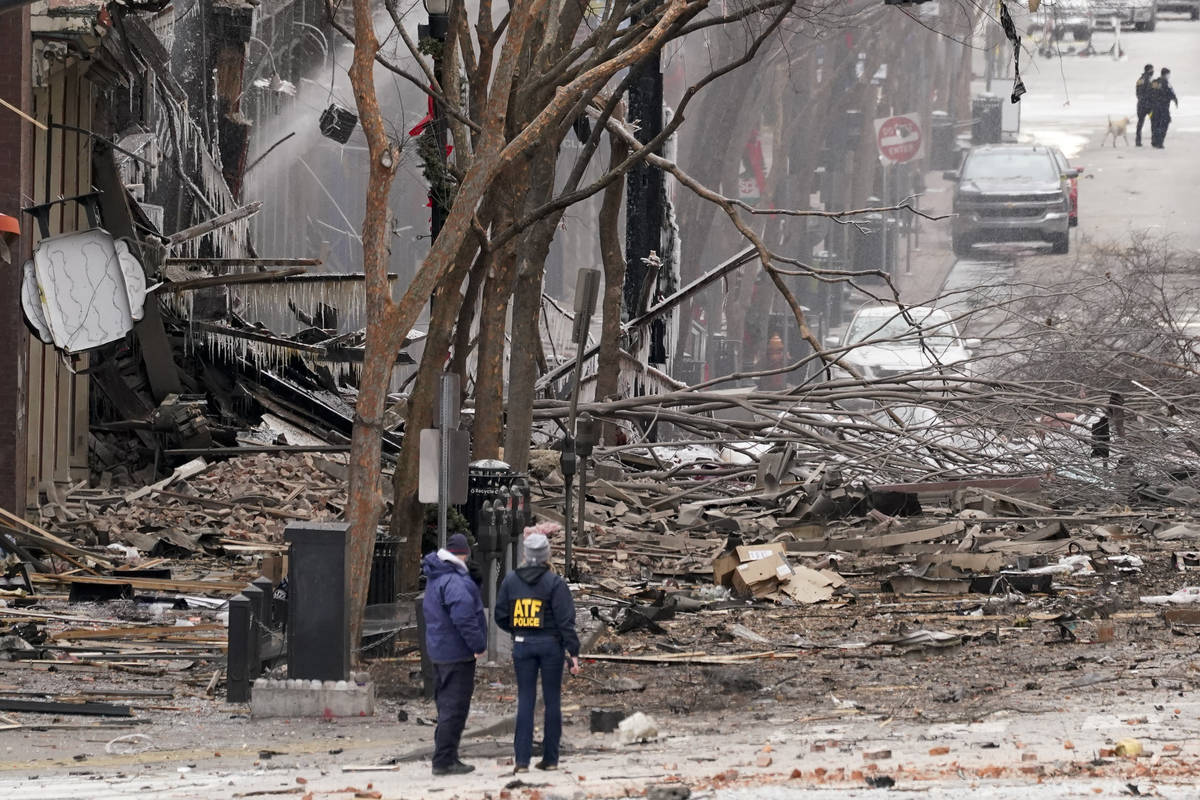 Emergency personnel work near the scene of an explosion in downtown Nashville, Tenn., Friday, D ...