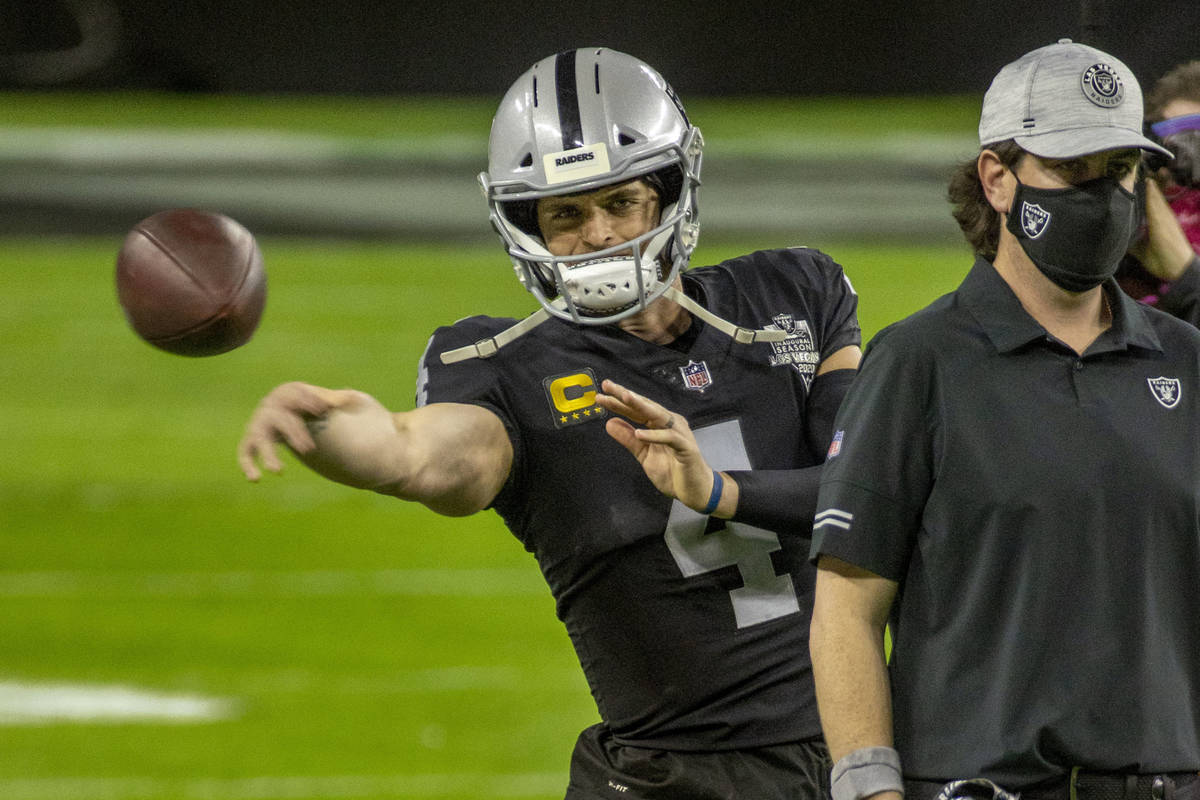 Raiders quarterback Derek Carr (4) tosses a side-arm pass during warm ups before an NFL footbal ...